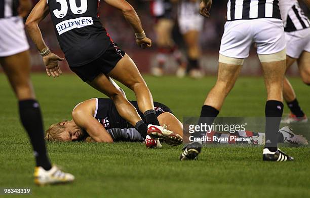 Nick Riewoldt of the Saints lies on the ground in pain after injuring his hamstring during the round three AFL match between the St Kilda Saints and...