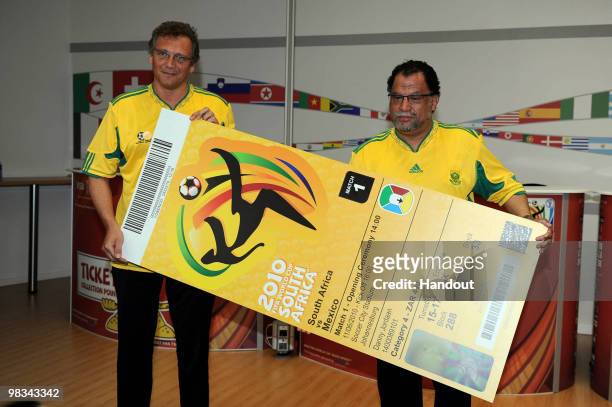 In this handout image provided by the 2010 FIFA World Cup Organising Committee South Africa, Jerome Valcke and Danny Jordaan hold up the official...
