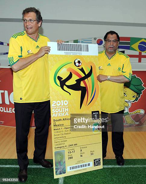 In this handout image provided by the 2010 FIFA World Cup Organising Committee South Africa, Jerome Valcke and Danny Jordaan hold up the official...