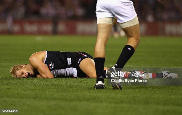 Nick Riewoldt of the Saints lies on the ground in pain after injuring his hamstring during the round three AFL match between the St Kilda Saints and...