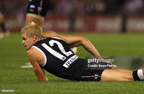 Nick Riewoldt of the Saints lies on the ground in pain after injuring his hamstring during the round three AFL match between the St Kilda Saints and...