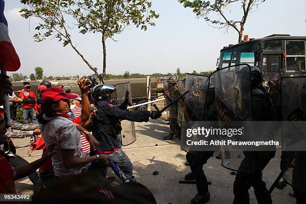 Red shirt supporter of former PM Thaksin Shinawatra confronts soldiers at a television satellite center on April 09, 2010 in Bangkok,Thailand. Tear...