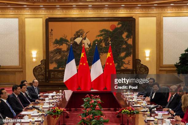 China's Premier Li Keqiang speaks to French Prime Minister Edouard Philippe during a meeting at the Great Hall of the People on June 25, 2018.