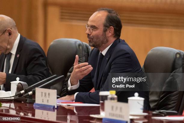 China's Premier Li Keqiang speaks to French Prime Minister Edouard Philippe during a meeting at the Great Hall of the People on June 25, 2018.