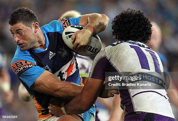 Mark Minichiello of the Titans takes on the Storm defence during the round five NRL match between the Gold Coast Titans and the Melbourne Storm at...