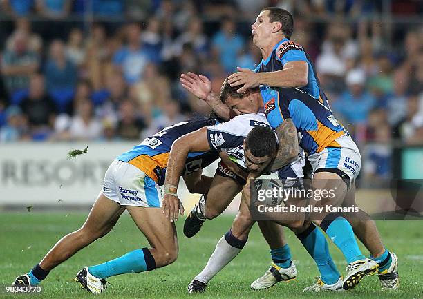 Greg Inglis of the Storm is tackled during the round five NRL match between the Gold Coast Titans and the Melbourne Storm at Skilled Park on April 9,...