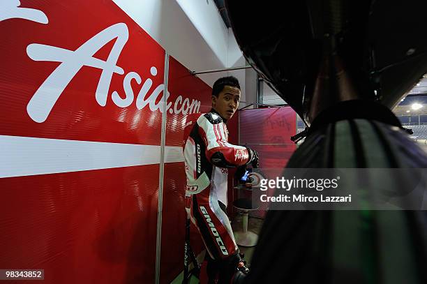 Muhammad Zulfahmi of Malaysia and Air Asia - Sepang Int. Circuit looks on near his bike during the first Grand Prix of the 2010 season at Losail...