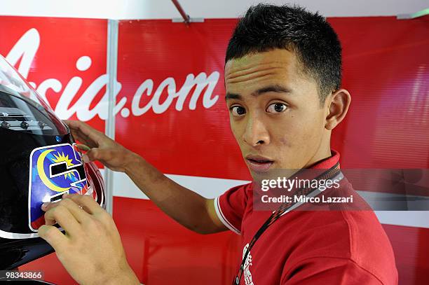 Muhammad Zulfahmi of Malaysia and Air Asia - Sepang Int. Circuit looks on in front his bike during the first Grand Prix of the 2010 season at Losail...