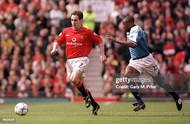 Gary Neville of Man United battles with Paulo Wanchope of Man City during the Manchester United v Manchester City FA Carling Premiership match at Old...