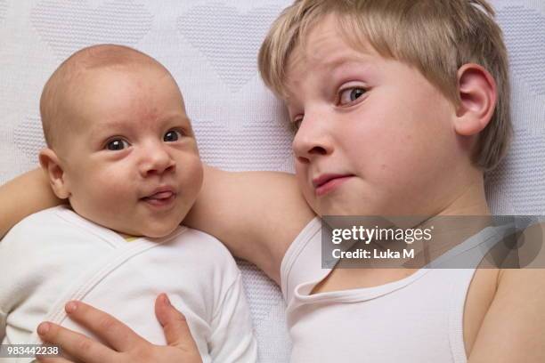 younger and older brother hugging brotherly love - brother love stock pictures, royalty-free photos & images