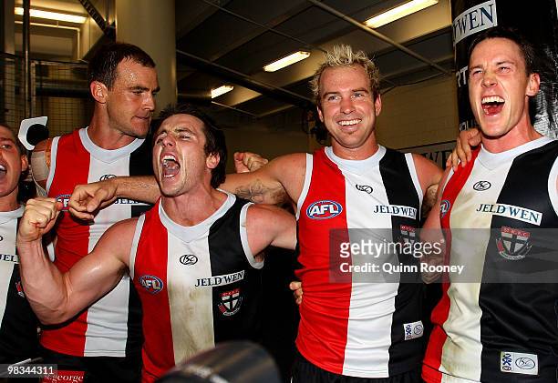 Steven King, Stephen Milne, Jason Gram and Jason Blake of the Saints sing the songs in the room after winning the round three AFL match between the...
