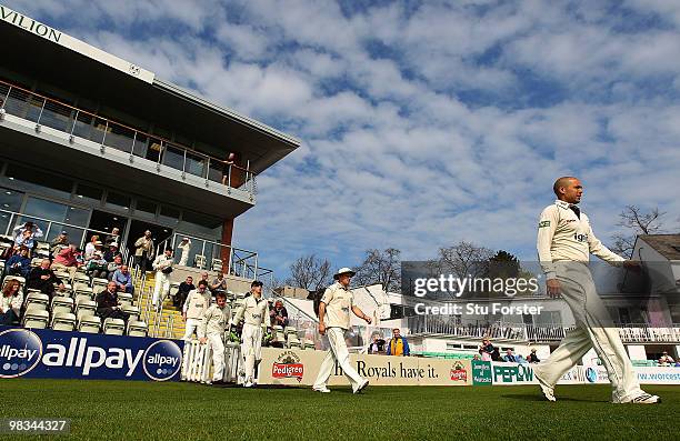 Middlesex batsman and England captain Andrew Strauss enters the field of play with his team mates for the start of the first day of the LV County...