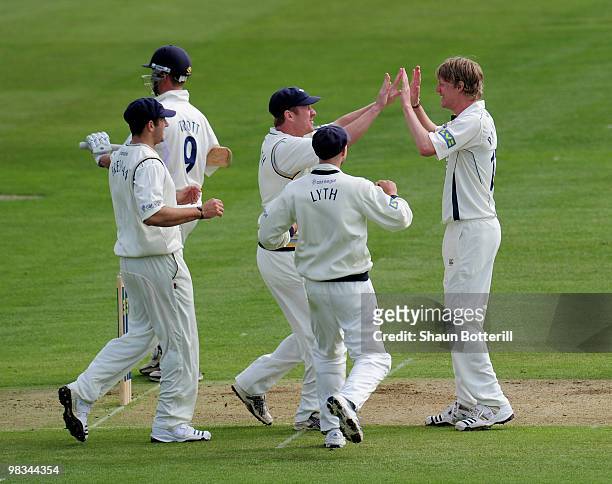 Steven Patterson of Yorkshire is congratulated by team-mates after taking the wicket of Jonathan Trott of Warwickshire during the LV County...