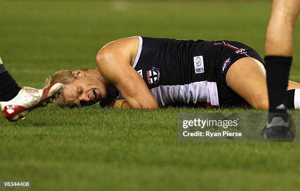 Nick Riewoldt of the Saints lies on the ground in pain after injuring his hamstring during the round three AFL match between the St Kilda Saints and...