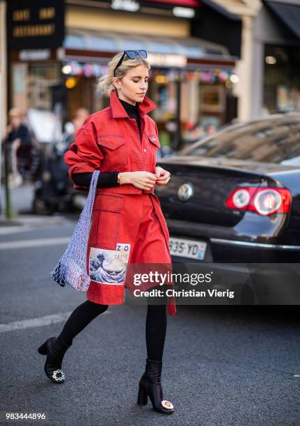 Caroline Daur wearing red coat, net bag is seen outside Kenzo on day six of Paris Fashion Week Menswear SS19 on June 24, 2018 in Paris, France.