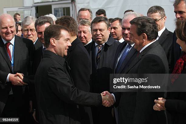 Russian President Dmitry Medvedev and Head of the Nord Stream, Former German Chancellor Gerhard Schroeder shakes hands at a ceremony to mark the...