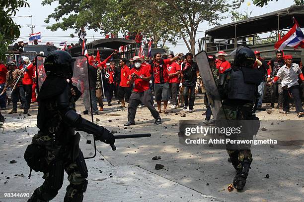 Red Shirt supporters of former PM Thaksin Shinawatra throw rocks at soldiers at a television satellite center on April 09, 2010 in Bangkok,Thailand....