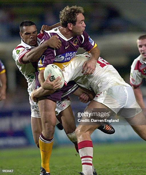 Gorden Tallis of the Broncos is tackled by Nathan Blacklock and Andrew Hart of the Dragons during the round ten NRL game between the Brisbane Broncos...