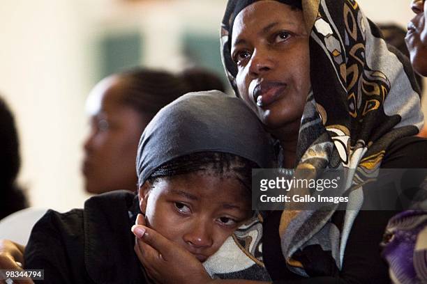 Kgomotso Sefularo comforts her daughter, Ipeleng during the memorial service for South African Deputy Minister Of Health Molefi Sefularo on April 8,...