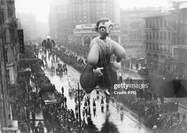 Giant Eddie Cantor balloon, followed by the Big Bad Wolf, in Macy's Thanksgiving Day Parade, New York City, 22nd November 1934.