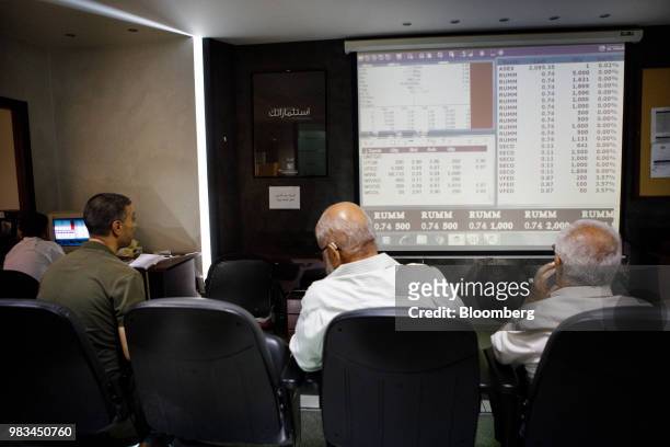 Investors watch trading screens at the International Financial Center at the Housing Bank Complex in Amman, Jordan, on Thursday, June 21, 2018....