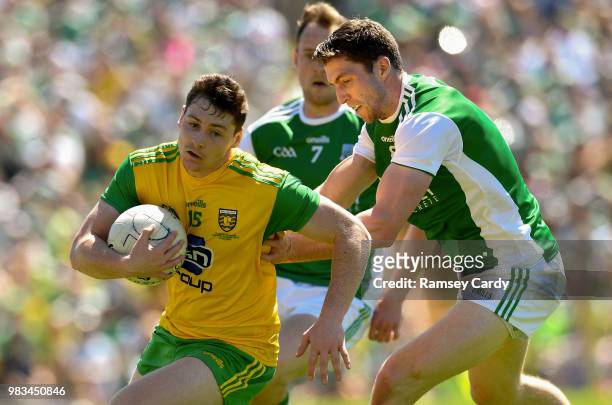 Monaghan , Ireland - 24 June 2018; Jamie Brennan of Donegal is tackled by Eoin Donnelly of Fermanagh during the Ulster GAA Football Senior...