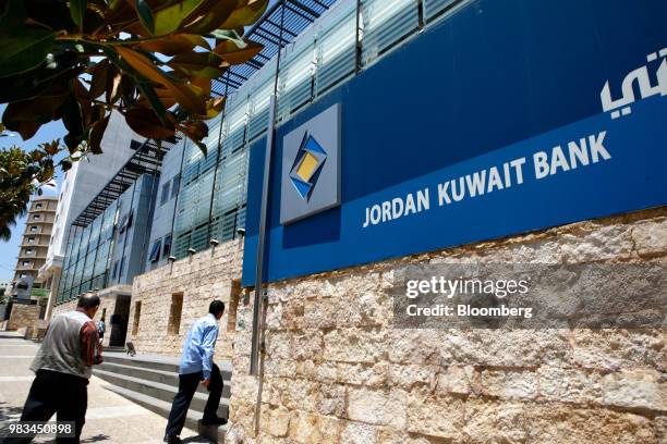 Visitors approach the entrance to the Jordan Kuwait Bank in Amman, Jordan, on Thursday, June 21, 2018. President Trump and First Lady Melania Trump...