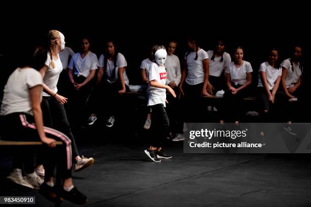 June 2018, Germany, Berlin: Two students from the Manfred von Ardenne High School Berlin wearing masks and dancing before classmates during the award...