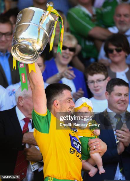 Monaghan , Ireland - 24 June 2018; Paddy McGrath of Donegal with his daughter Isla Rose lifts the trophy following the Ulster GAA Football Senior...