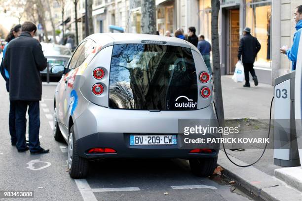 An Autolib electric bluecar is plugged at a charging station on December 2, 2011 in Paris, on the day of the official presentation of this public...