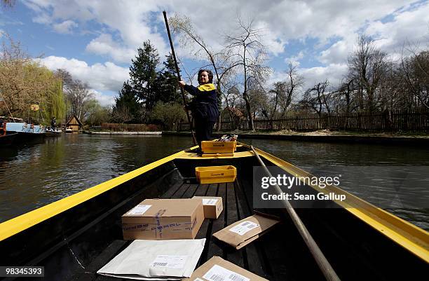 Jutta Pudenz, an employee of German postal carrier Deutsche Post DHL, navigates her falt-bottomed canoe through the narrow canals in the Spreewald...