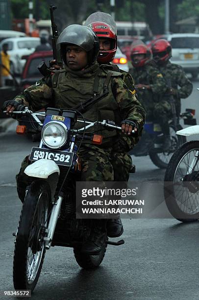 Armed Sri Lankan amy commandos patrol on motorcycles in Colombo on April 9, 2010. Sri Lanka's ruling party cruised to victory Friday in parliamentary...