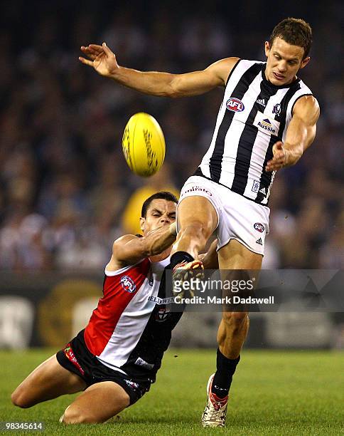Luke Ball of the Magpies kicks as he is tackled by Brett Peake of the Saints during the round three AFL match between the St Kilda Saints and the...