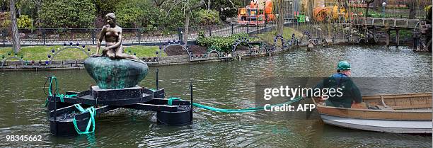 The family-owned copy of The Little Mermaid made by Edvard Eriksen in 1913 is placed in the Tivoli Lake in Copenhagen on April 9, 2010. The unveiling...