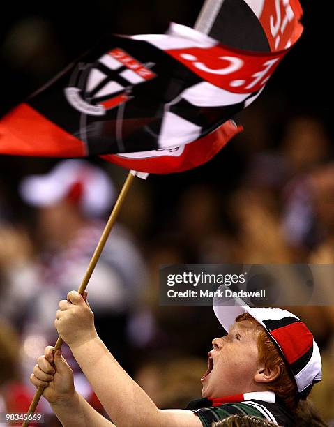 Young St Kilda fan waves his flag after a goal during the round three AFL match between the St Kilda Saints and the Collingwood Magpies at Etihad...