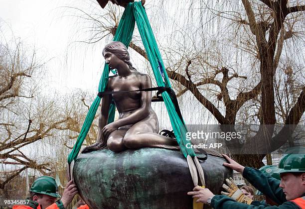 The family-owned copy of The Little Mermaid made by Edvard Eriksen in 1913 is placed in the Tivoli Lake in Copenhagen on April 9, 2010. The unveiling...