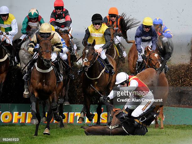 Khachaturian and Jason Maguire fall during The matalan.co.uk Mildmay Novices' Steeple Chase at Aintree racecourse on April 09, 2010 in Liverpool,...