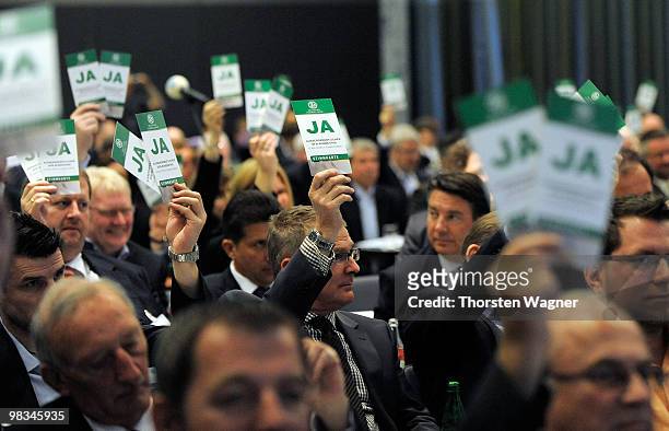 Voting cards are held in the air during the German Football Association Bundestag at the Steigenberger Airport Hotel on April 9, 2010 in Mainz,...