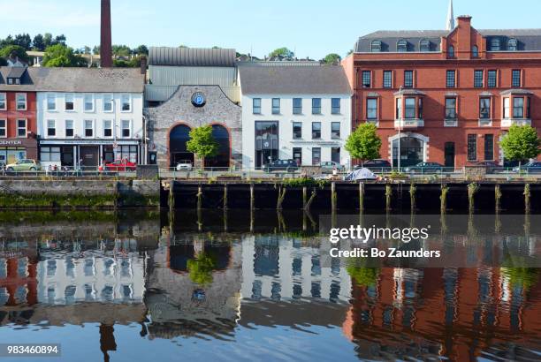 buildings in cork, ireland, reflected in the river lee. - cork tree bildbanksfoton och bilder