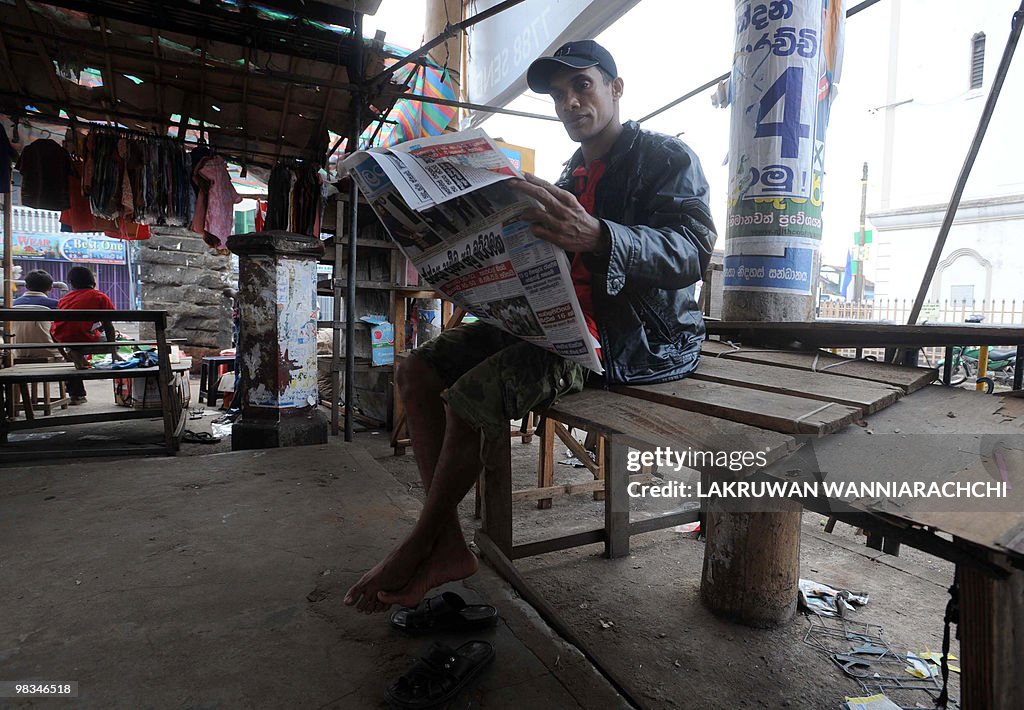 A man reads a newspapers on the streets