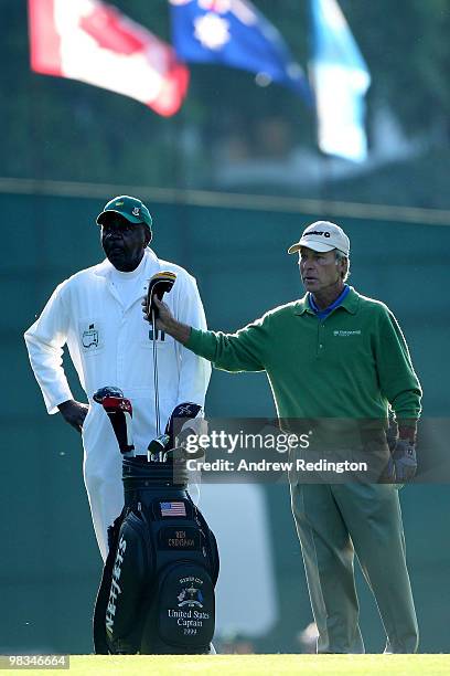 Ben Crenshaw pulls a club as his caddie Carl Jackson looks on during the second round of the 2010 Masters Tournament at Augusta National Golf Club on...