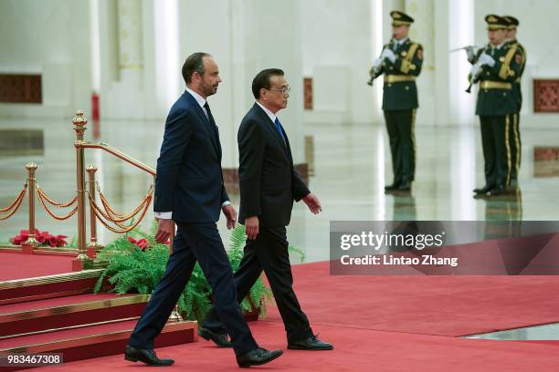 Chinese Premier Li Keqiang invites French Prime Minister Edouard Philippe to view an honour guard during a welcoming ceremony inside the Great Hall...