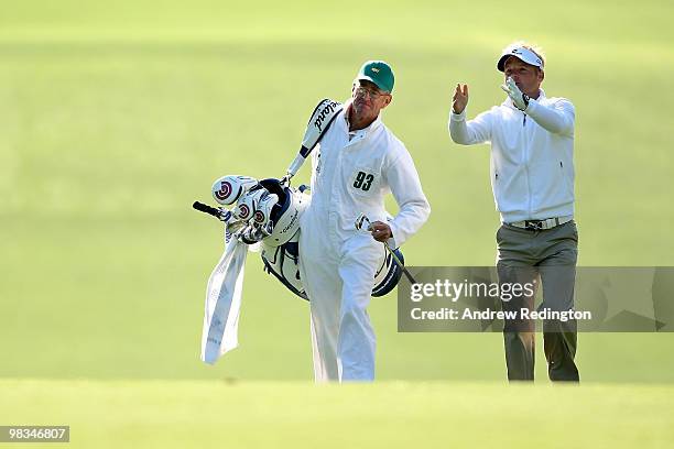 Soren Kjeldsen of Denmark talks with is caddie Kevin Woodward on the first hole during the second round of the 2010 Masters Tournament at Augusta...