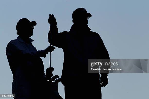 Sandy Lyle of Scotland pulls a club as his caddie Ken Martin looks on during the second round of the 2010 Masters Tournament at Augusta National Golf...