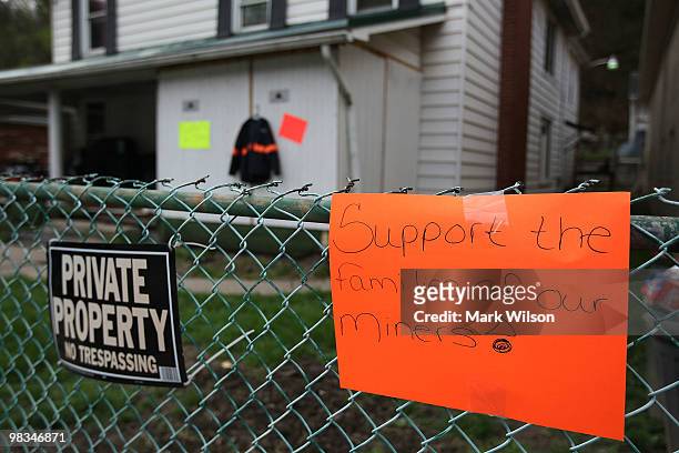 Sign showing support for coal miners hangs on a fence on April 9, 2010 in Whitesville, West Virginia. Rescuers had to pull out of the Upper Big...