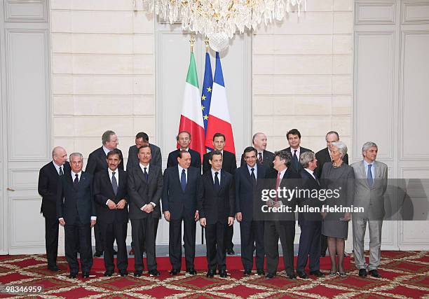 French President Nicolas Sarkozy and Italian Prime Minister Silvio Berlusconi pose for photographers with their ministers after a working lunch at...