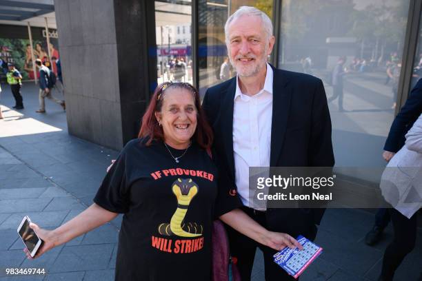 Labour Party leader Jeremy Corbyn poses for a picture with a supporter following a demonstration calling for the renationalisation of the rail...