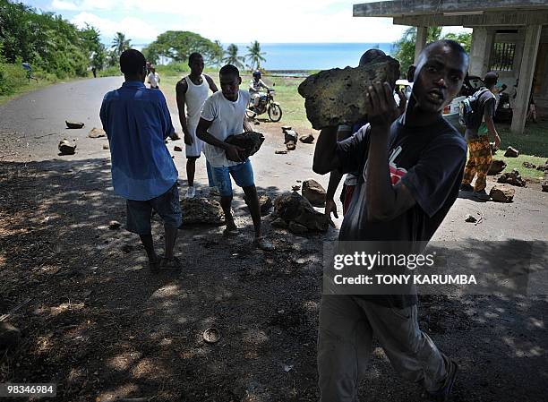 Protestors use boulders to block a road as they march in a street of Moheli [Mwali] on April 09, 2010 to demonstrate against President Ahmed Abdalla...