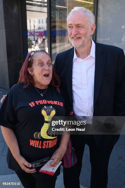 Labour Party leader Jeremy Corbyn poses for a picture with a supporter following a demonstration calling for the renationalisation of the rail...