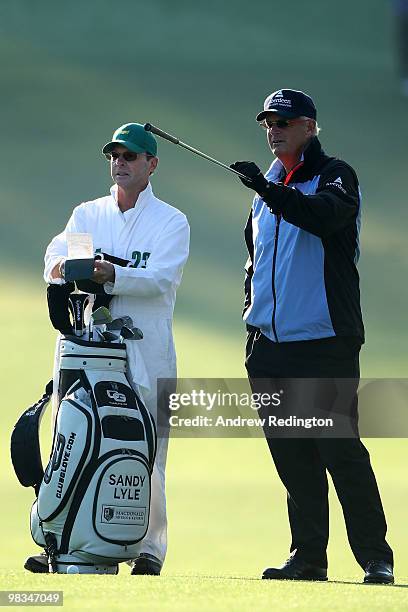 Sandy Lyle talks with his caddie Ken Martin on the first fairway during the second round of the 2010 Masters Tournament at Augusta National Golf Club...